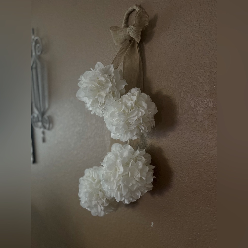 Artificial hanging hydrangeas in white with burlap ribbon.